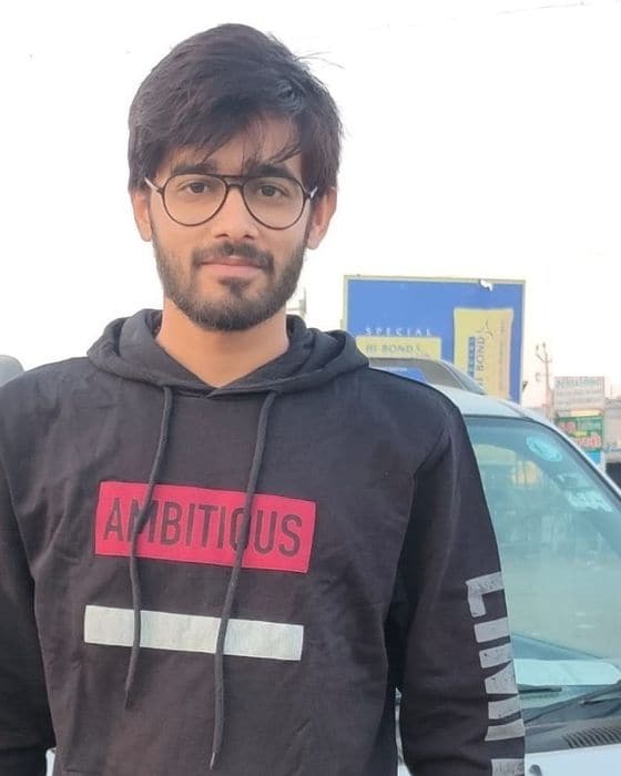 Tejas Parmar standing outdoors in a black hoodie
