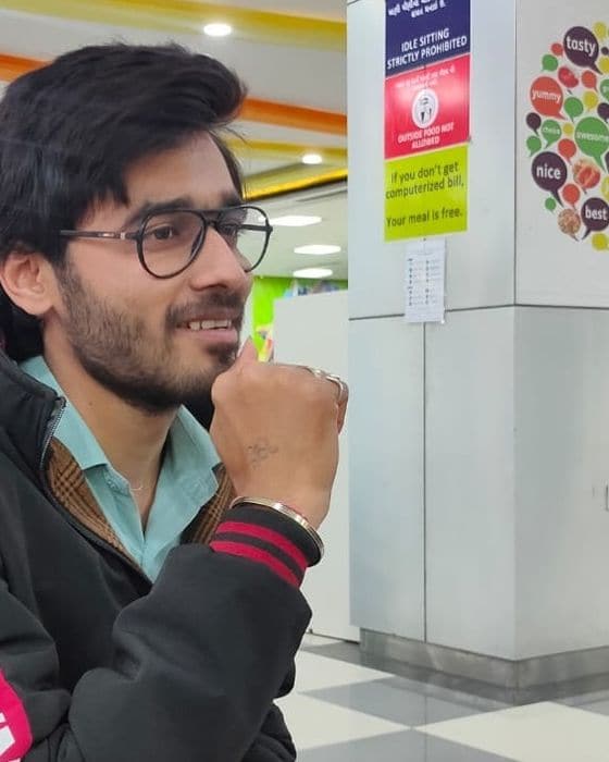Tejas Parmar smiling in a black jacket